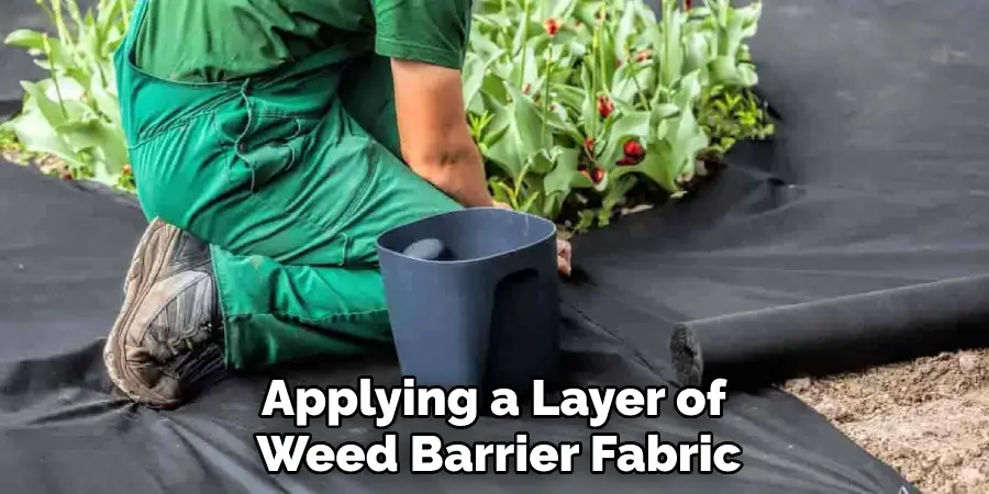 Applying a Layer of Weed Barrier Fabric