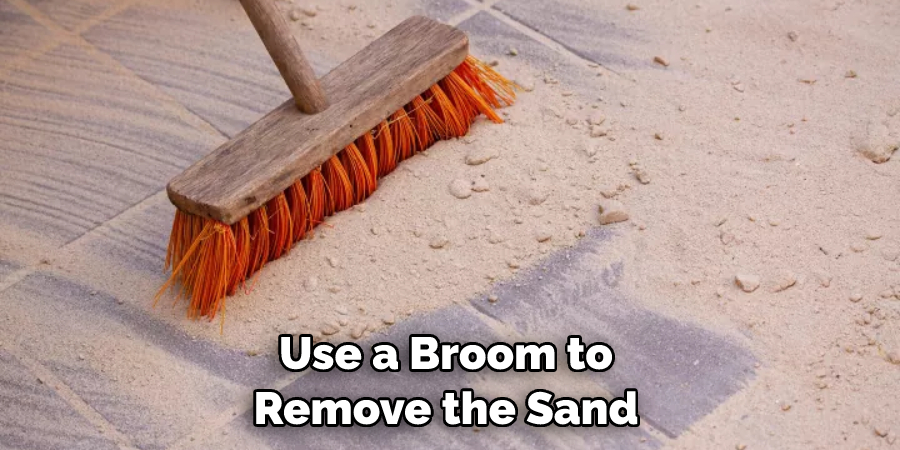 Use a Broom to Remove the Sand