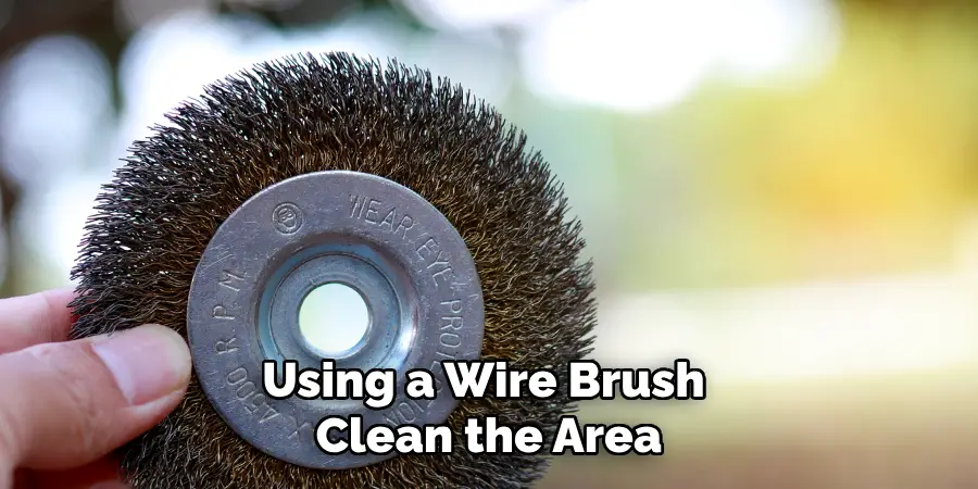 Using a Wire Brush Clean the Area