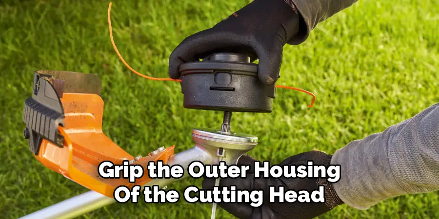 Grip the Outer Housing
Of the Cutting Head