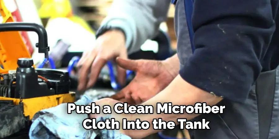 Push a Clean Microfiber Cloth Into the Tank