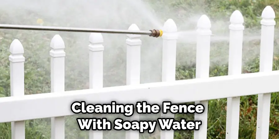 Cleaning the Fence With Soapy Water