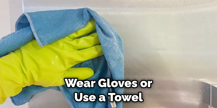 Wear gloves or use a towel